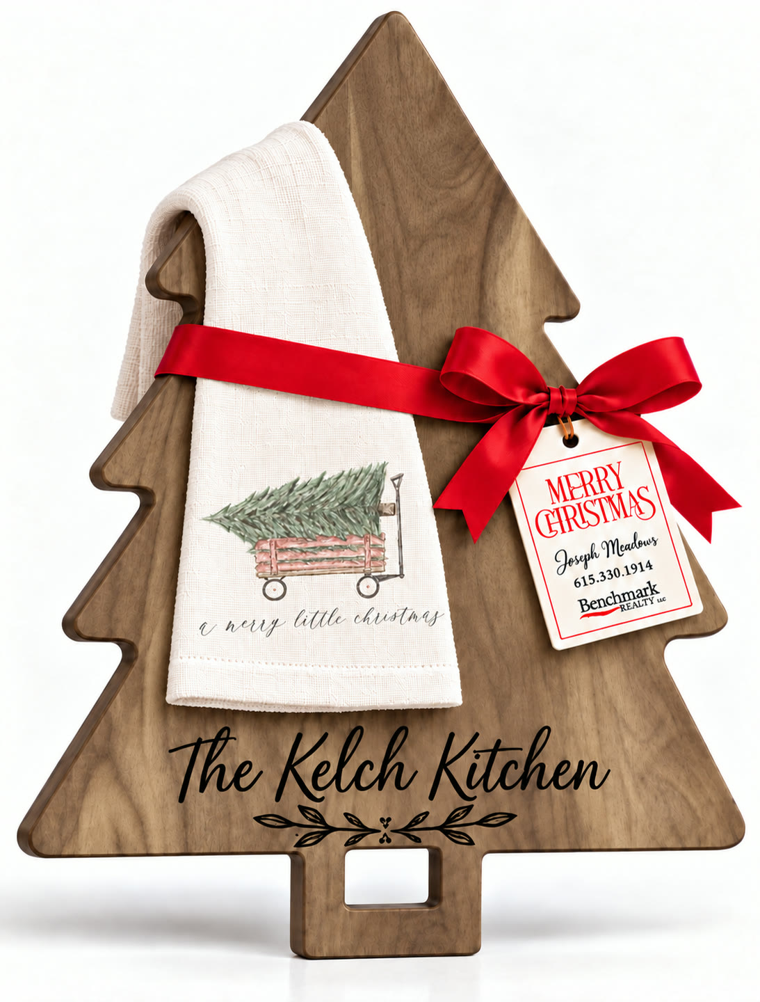 Tree-shaped engraved board with a kitchen towel in the A Merry Little Christmas (Tree in Wagon) design