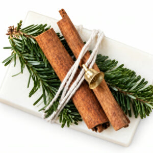 Bar soap tied with evergreen sprigs, cinnamon sticks, and a gold bell