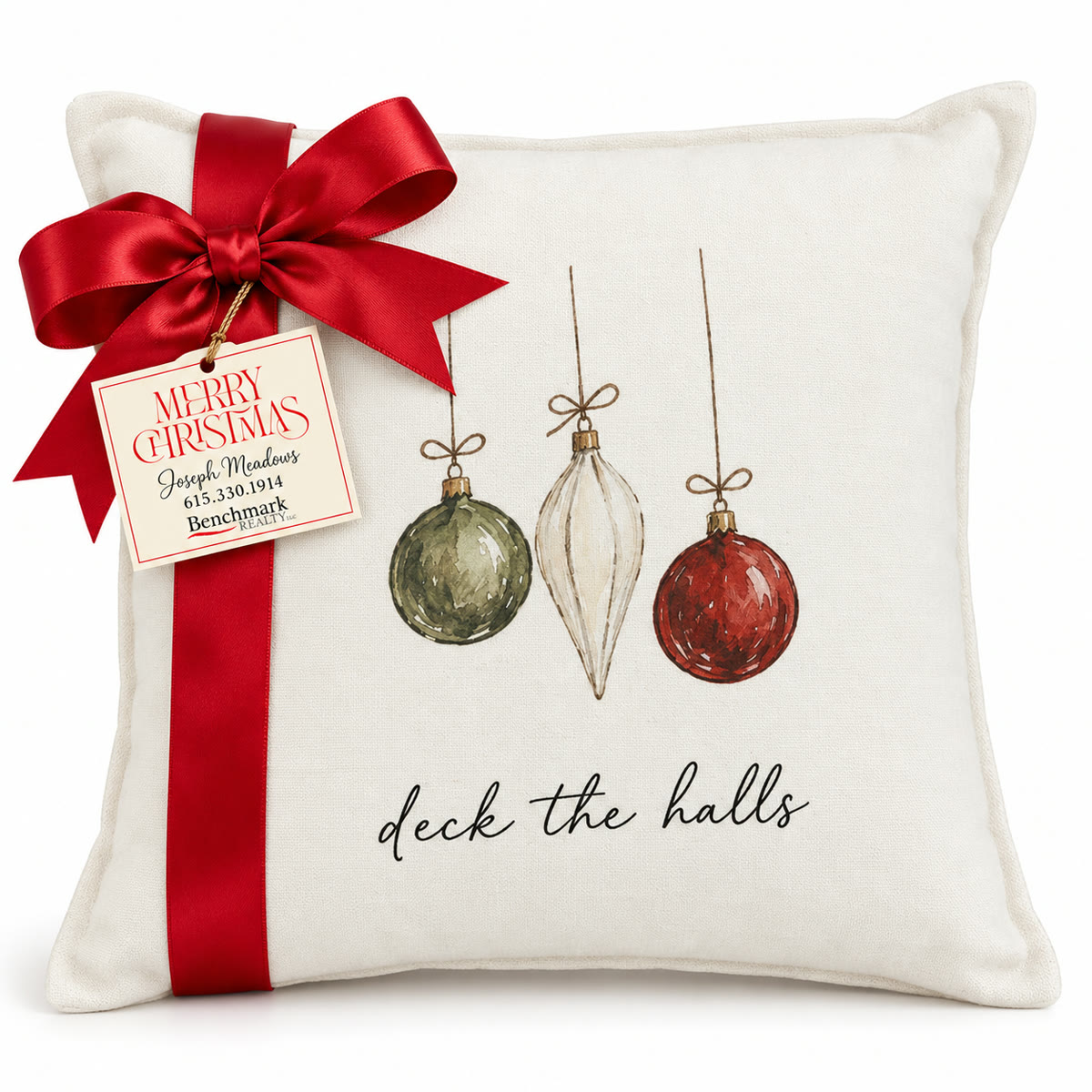 Cream pillow with watercolor ornaments and deck the halls script