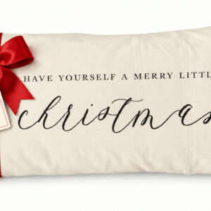 Cream lumbar pillow reading Have Yourself a Merry Little Christmas with red satin bow