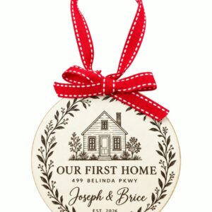 Our First Home personalized round wooden ornament with house illustration and red ribbon